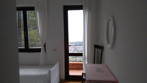 a bedroom with a bed and a window with a view at Hotel Ristorante Radar in Carrara