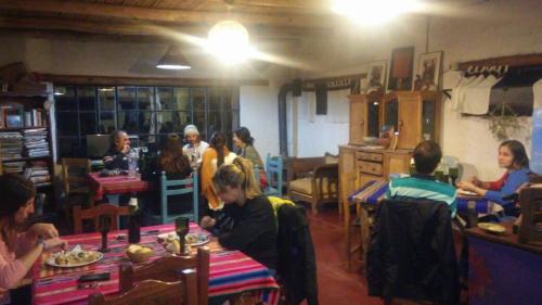 a group of people sitting at tables in a restaurant at Chakana Hospedaje Rural in Villa Unión