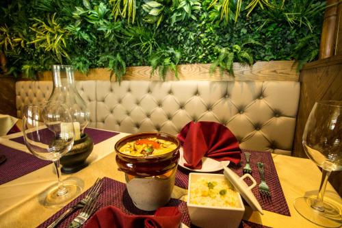 a table with a plate of food and wine glasses at Highfield Hotel in Houghton le Spring