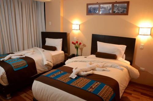 Tempat tidur dalam kamar di Kapac Inn Hotel