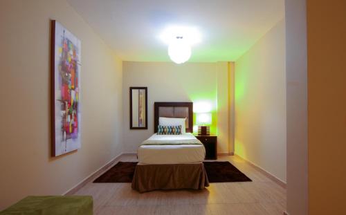 a bedroom with a bed and a table in it at Best Western Plus Accra Beach Hotel in Teshi