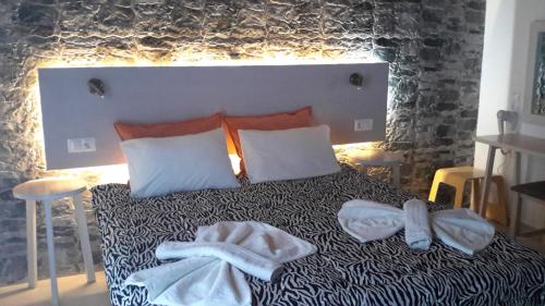 a bedroom with a bed with towels on it at Loutro Holidays in Loutro