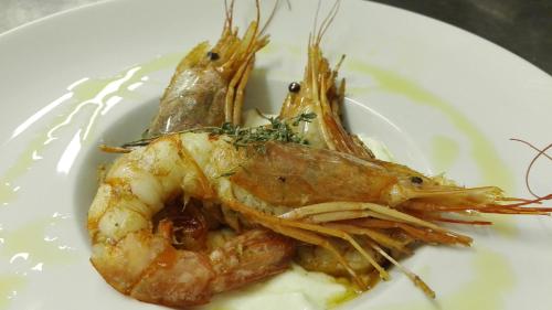 a plate of food with shrimp on a plate at Le Nicchie Guest House in Lucera