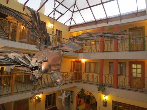 a sculpture of a dinosaur hanging from a building at Hotel Cima Argentum in Potosí