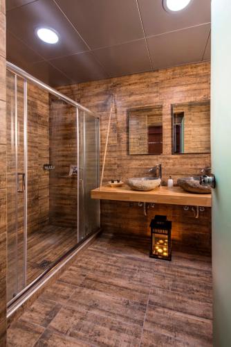 a bathroom with two sinks and a shower at Paxos Club Resort & SPA in Gaios