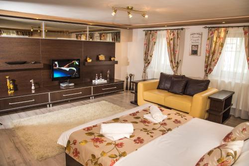 a living room with a bed and a couch at Casa Antonia Homestay in Şura Mică