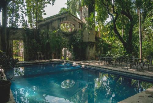 a swimming pool in a yard with trees at Hacienda San Gabriel de las Palmas in Amacuzac