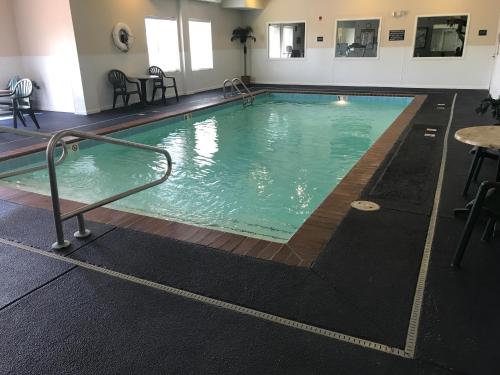 a large swimming pool in a hotel room at SureStay Plus Hotel by Best Western Billings in Billings