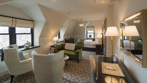 a hotel room with a living room with a suite at Sydney Boutique Inn & Suites in Charlottetown