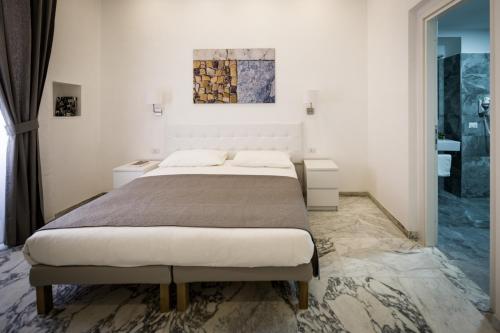 a bedroom with a large bed and two night stands at Vinci House in Rome