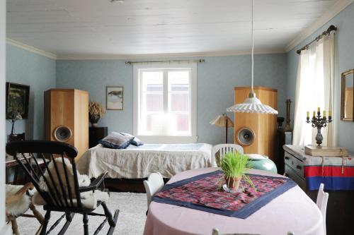 a bedroom with a bed and a table and chairs at 1800's Townhouse in Lovisa