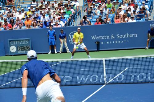 two men playing a game of tennis on a tennis court at Hawthorn Extended Stay by Wyndham Cincinnati NE Mason in Mason