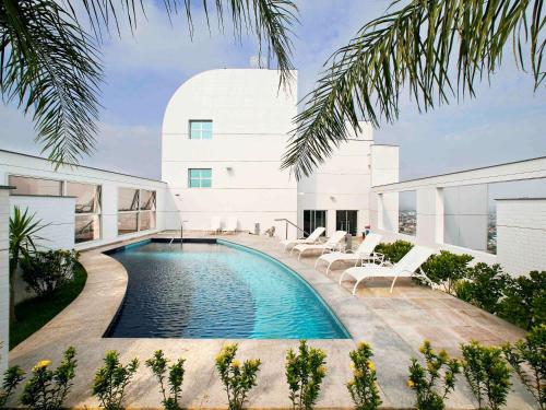 a swimming pool in the backyard of a house at Mercure Manaus in Manaus