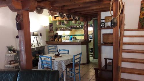 a kitchen and dining room with a table and chairs at La Grange in Durban-Corbières