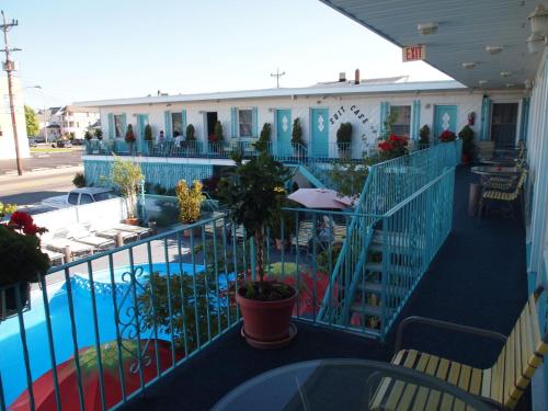 a balcony of a building with a swimming pool at Suitcase Motel & Travel in North Wildwood