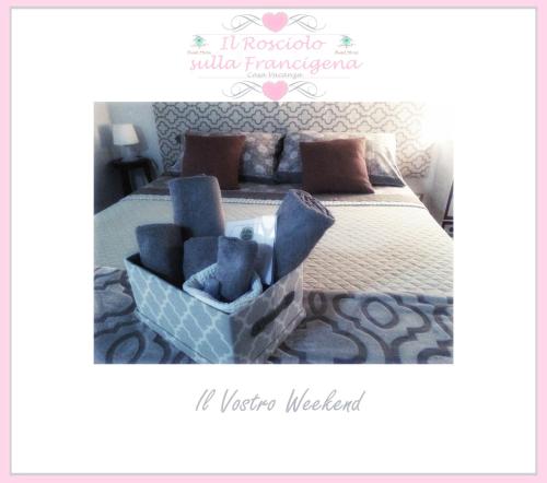 a bedroom with a large bed with a blue chair at Il Rosciolo Sulla Francigena in Formello
