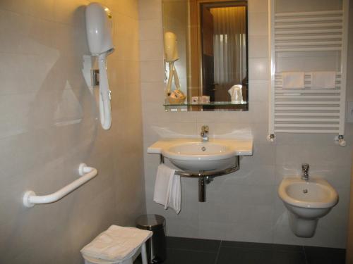 a bathroom with a sink and a toilet at Hotel Vittoria in San Giovanni Rotondo