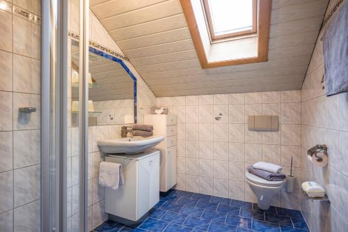 a bathroom with a sink and a toilet at Ferienwohnung Spindlegger in Schlitters
