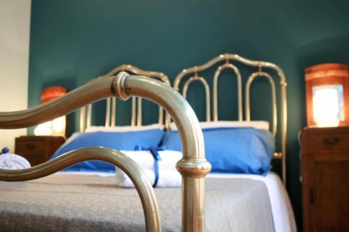 a bedroom with two beds with blue sheets at Chez Moi Charme B&B in Lecce