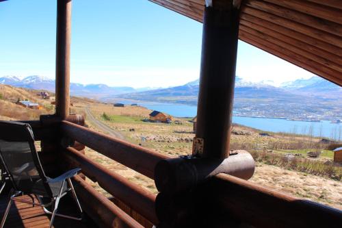 a room with a view of a lake and mountains at Akureyri Log Cabin in Akureyri