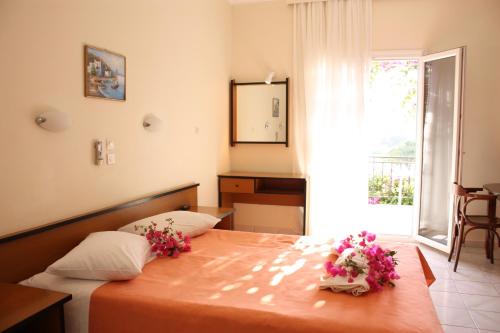 a bedroom with a bed with flowers on it at Aktio Studios in Gavrion