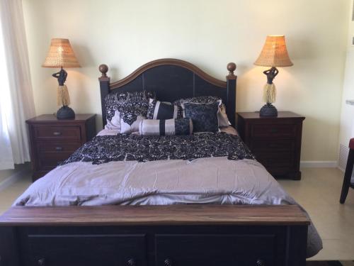 a bedroom with a large bed with two lamps at Waikiki Ala Moana Studio in Honolulu