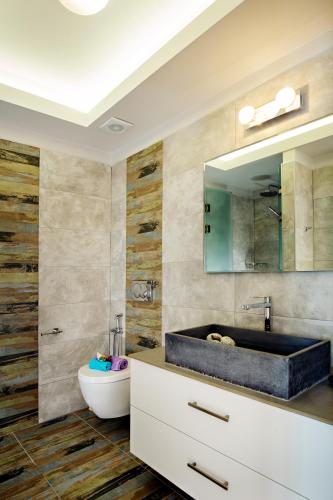 a bathroom with a tub and a sink and a mirror at Beachside Apartment in Plakias centre! in Plakias