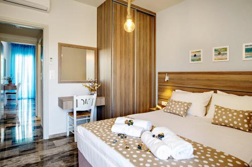 a hotel room with a bed with towels on it at Beachside Apartment in Plakias centre! in Plakias