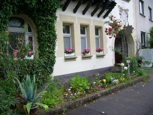 a house with flowers on the side of it at Pension Haus Weller in Boppard