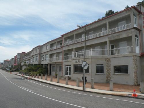 a row of buildings on the side of a street at Hotel Rompeolas in Baiona