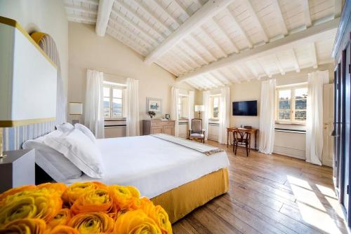 a large bedroom with a large white bed in a room at Borgo Del Cabreo in Greve in Chianti