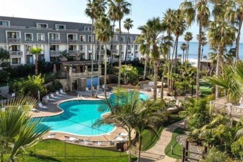 an aerial view of a resort with a pool and palm trees at Beachside Retreat in Oceanside