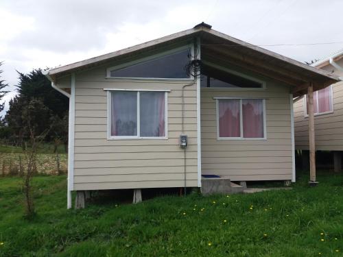 a house with a window on the side of it at Las Murtas de Chiloe-Cabañas in Chacao
