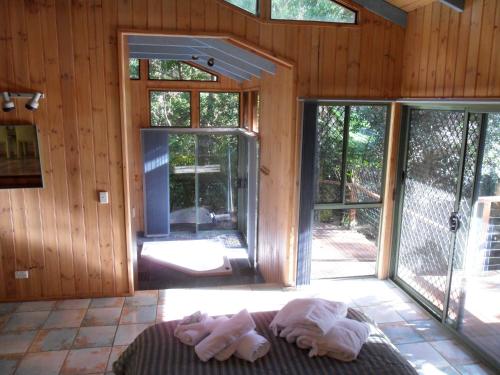 a room with sliding glass doors in a cabin at Treetops Montville in Montville