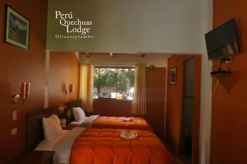 two beds in a room with two cats laying on them at Peru Quechua's Lodge Ollantaytambo in Ollantaytambo