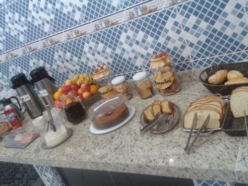 a counter with a bunch of food on it at Hotel Porto Real in Pôrto Real