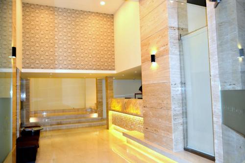 a lobby of a building with a staircase in it at Hotel Orion Premiere in Panaji