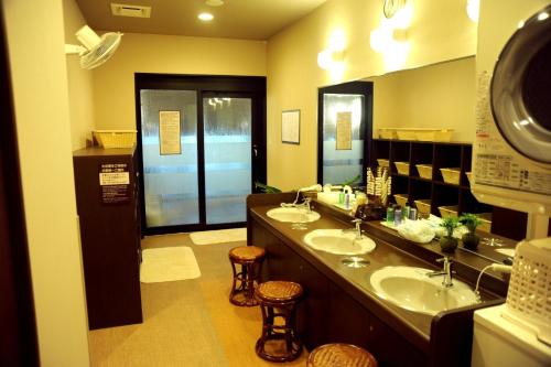 a bathroom with two sinks and two stools at Hotel Route-Inn Ena in Ena