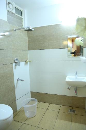 a bathroom with a toilet and a sink at 4U Business Hotel in Chennai