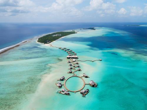 an island in the ocean with a group of resorts at Soneva Jani in Noonu