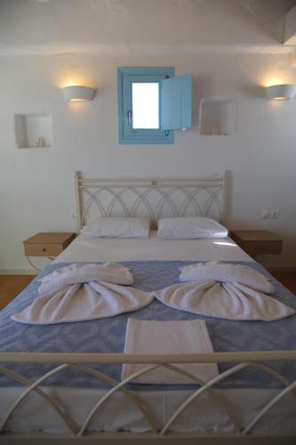 a bedroom with two beds with towels on them at Apollon Koufonisia Studios in Koufonisia