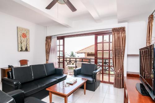 a living room with a couch and a table at Nongsa Point Marina in Nongsa