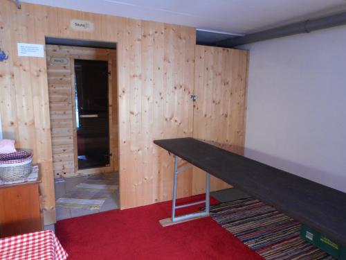 a room with a wooden wall with a table at Almidylle Kathrin in Strobl