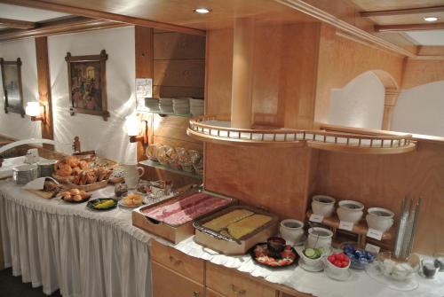 a kitchen with a table with food on it at Hotel Garni Central - Zimmer - Studios - Apartments in Kappl