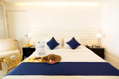a hotel room with a bed with a stuffed animal on it at Nongsa Point Marina in Nongsa