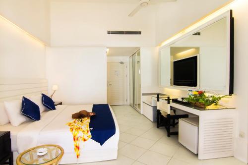 a bedroom with a bed and a desk in a room at Nongsa Point Marina in Nongsa