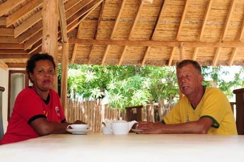 two men sitting at a table in a table sidx sidx sidx at Sandy Edge in Kalpitiya