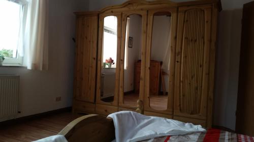 1 dormitorio con armario de madera y ventana en Ferienwohnung Rummel Selb, en Selb