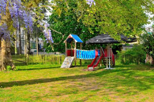 a playground in a park with a slide at Hotel Restaurant Le Paris in Mondorf-les-Bains