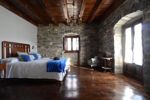 a room with a bed and a fireplace at Txantxorena in Zubiri